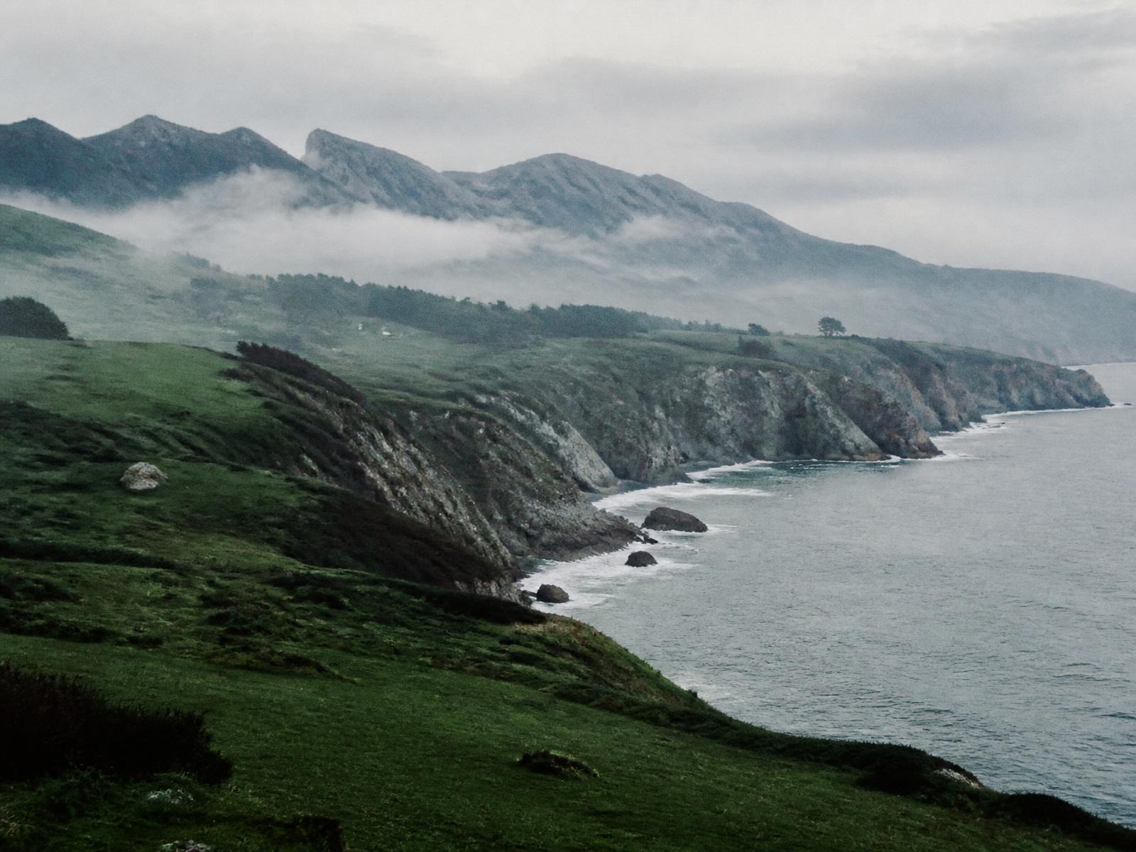 Green cliffs and sea mist along the Asturian coast